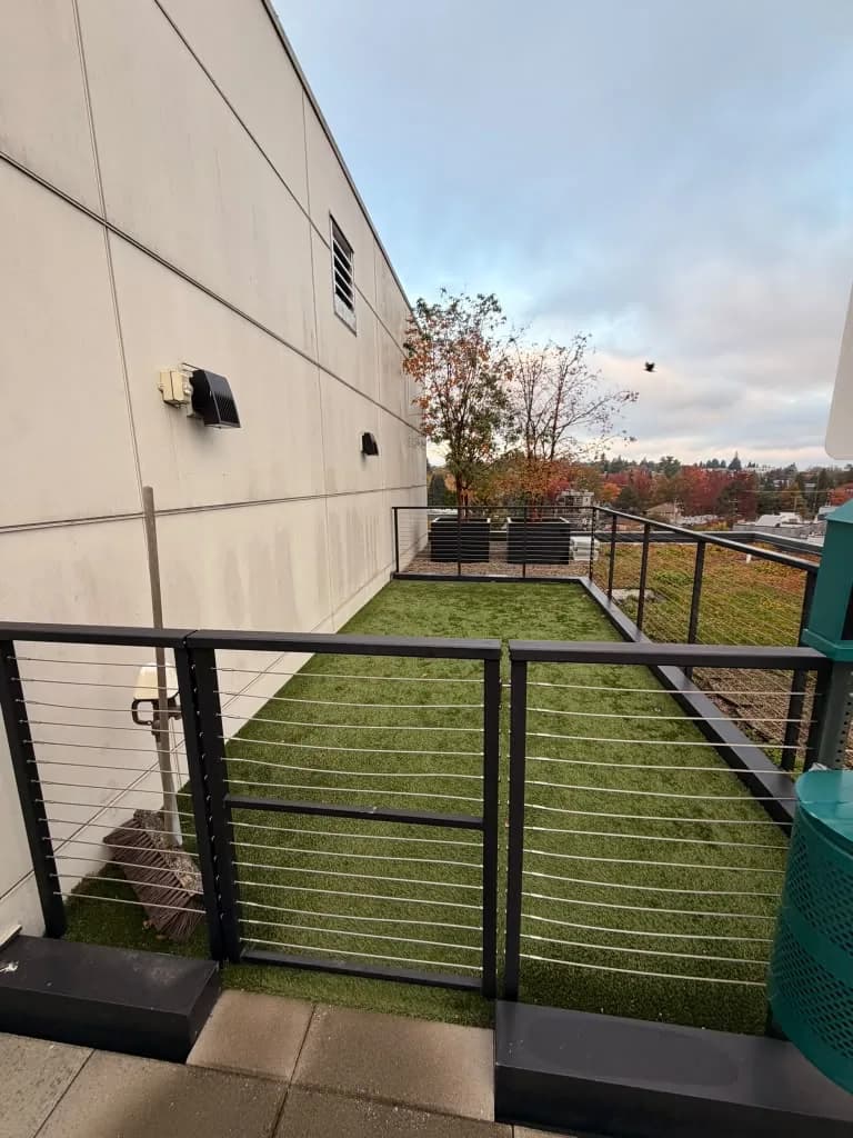 Fenced artificial turf area on the Avant Apartments rooftop