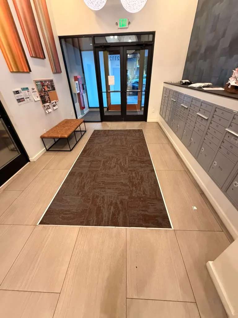 Lobby with mailboxes, bench and entry mat at Avant Apartments in Seattle