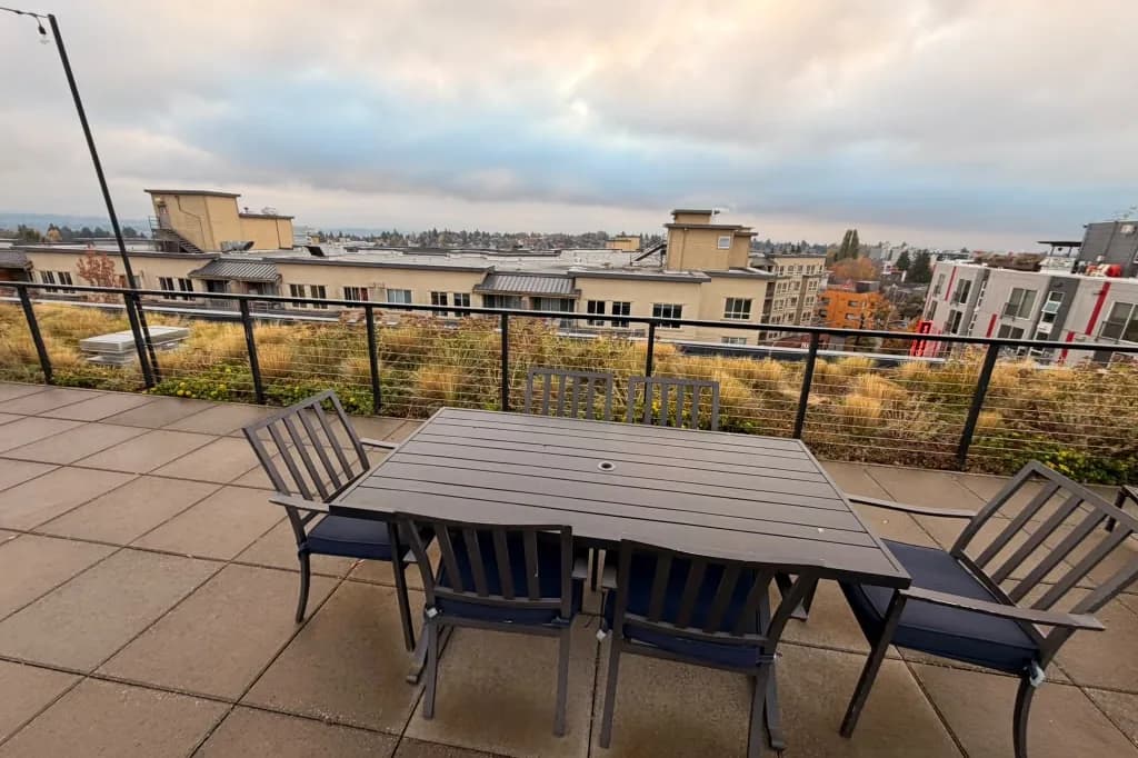 Rooftop dining table and chairs at Avant Apartments overlooking Seattle