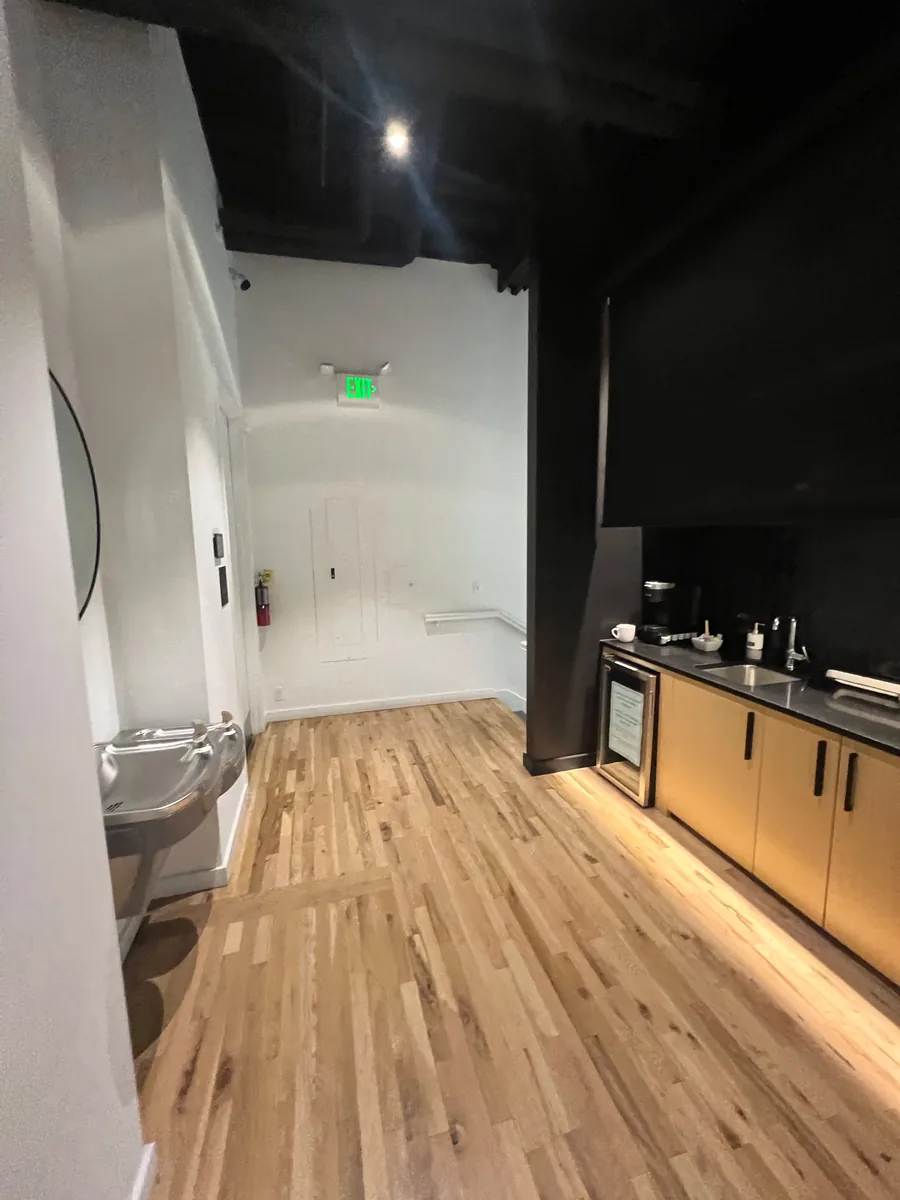 Back hallway with kitchenette and hardwood floor in a restaurant space