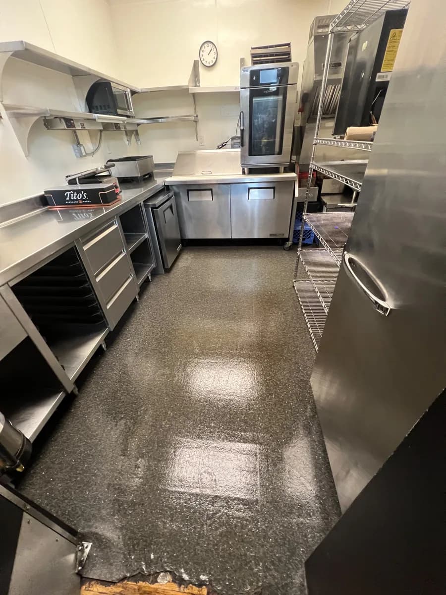 Restaurant kitchen floor and stainless equipment after cleaning