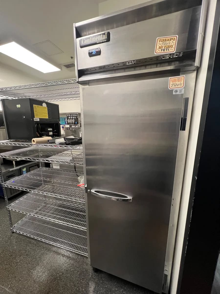 Stainless reach-in refrigerator and wire shelving in a restaurant kitchen in Bellevue