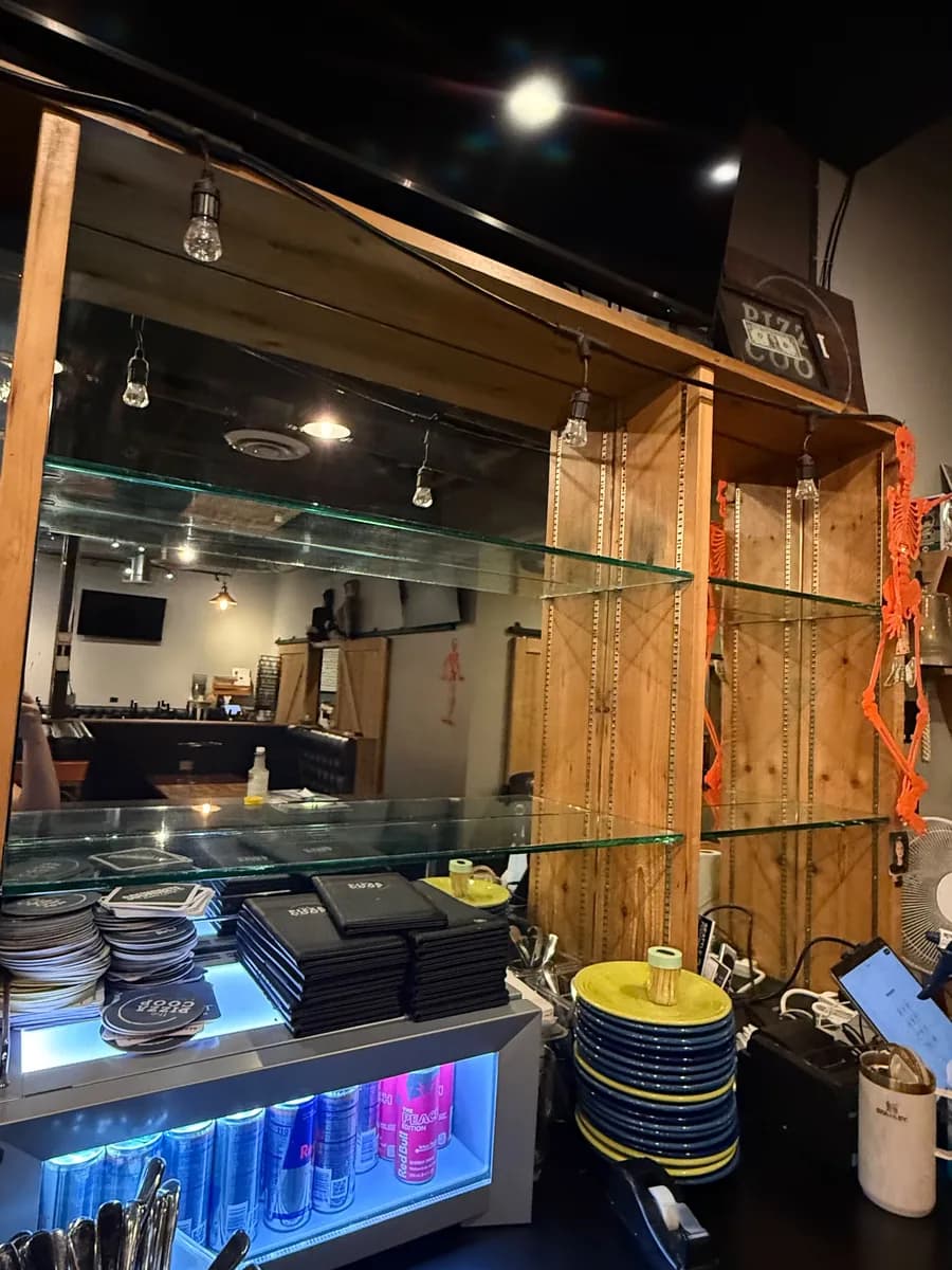 Service station with glass shelving and an under-counter cooler at The Pizza Coop & Ale House