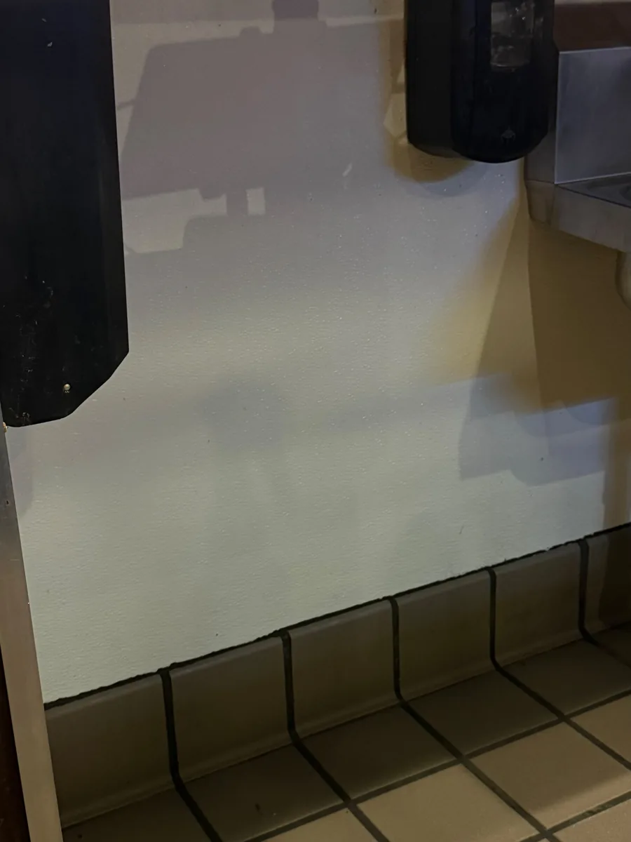 Kitchen wall, soap dispenser and tile cove base in a Woodinville restaurant