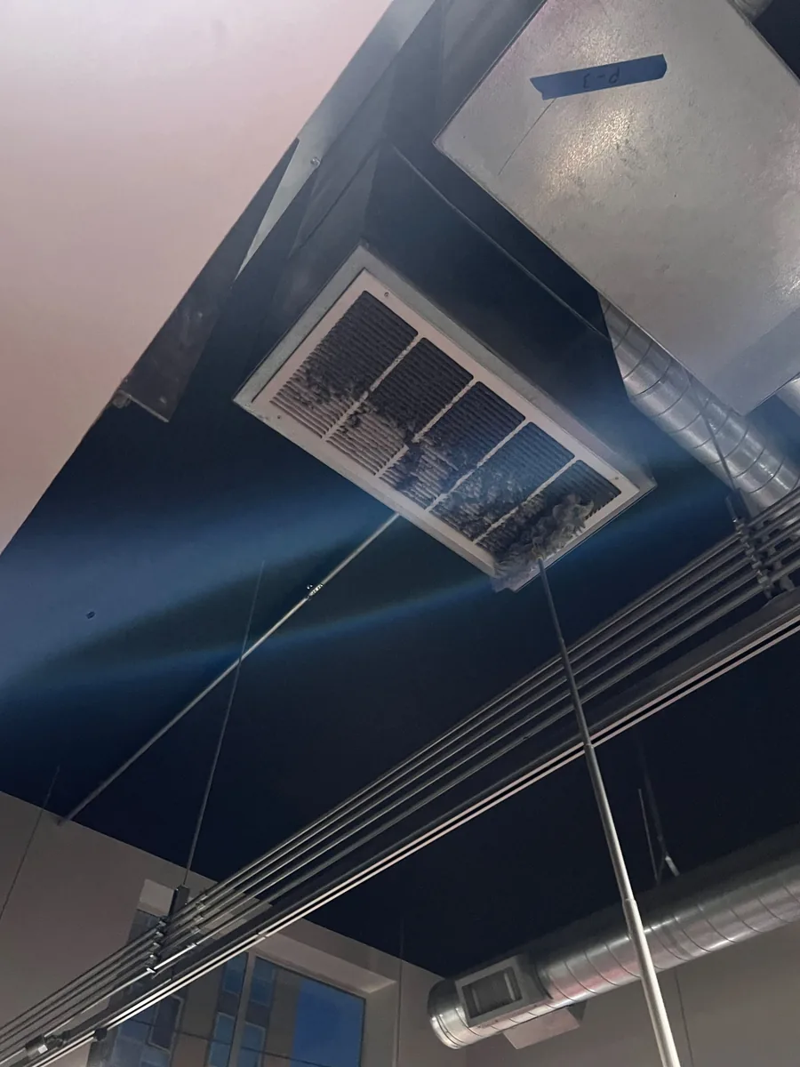 Dust built up on a ceiling return vent at Transform 180 before high dusting