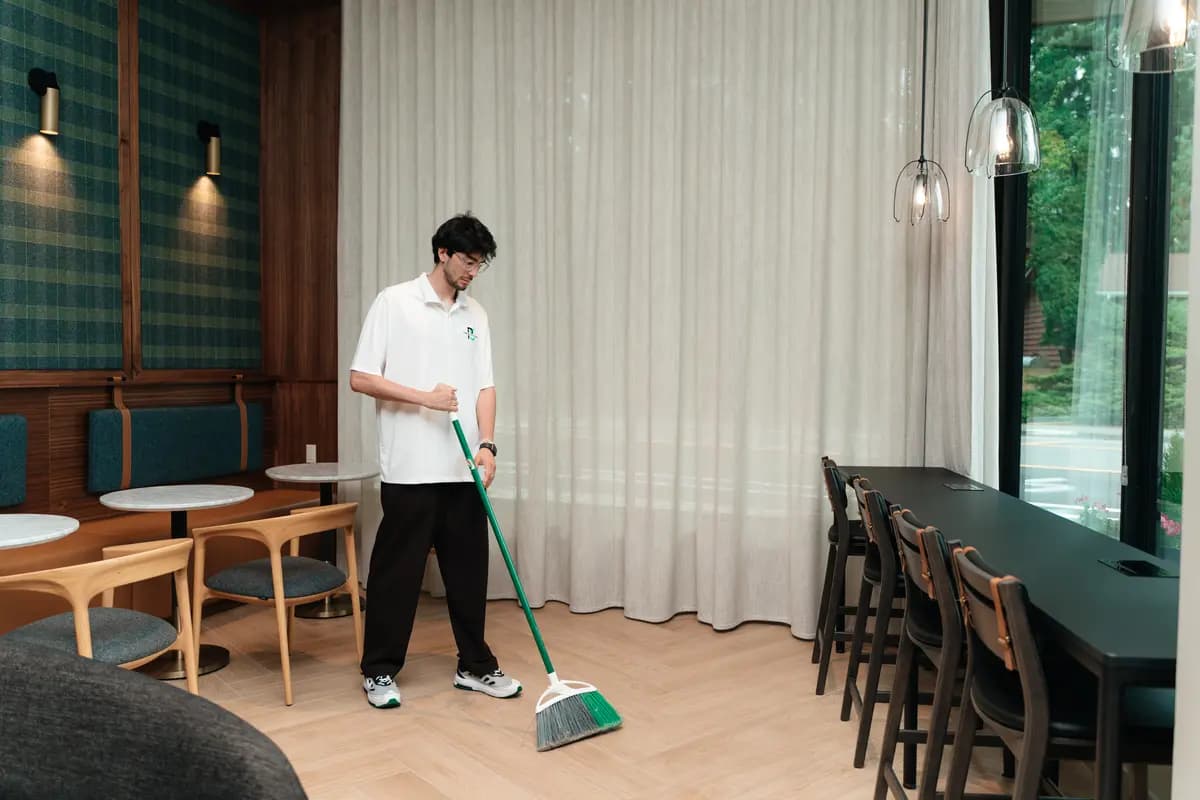 Sweeping the floor of a café and dining area before service