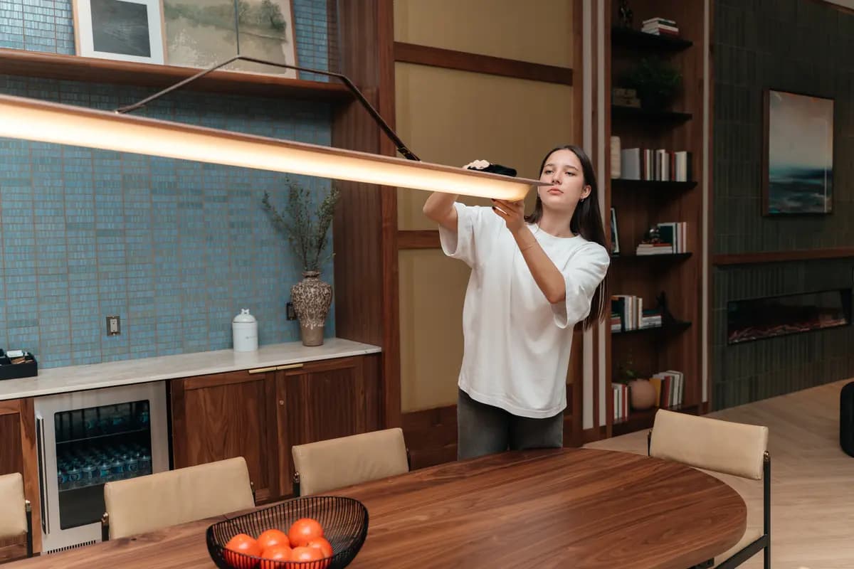 High dusting of a pendant light fixture over a conference table