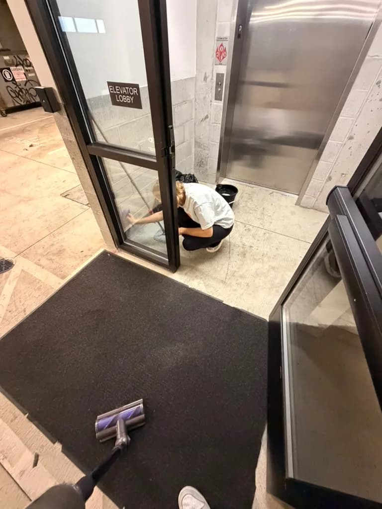 Cleaning the elevator lobby entrance and entry mat at Verve Flats