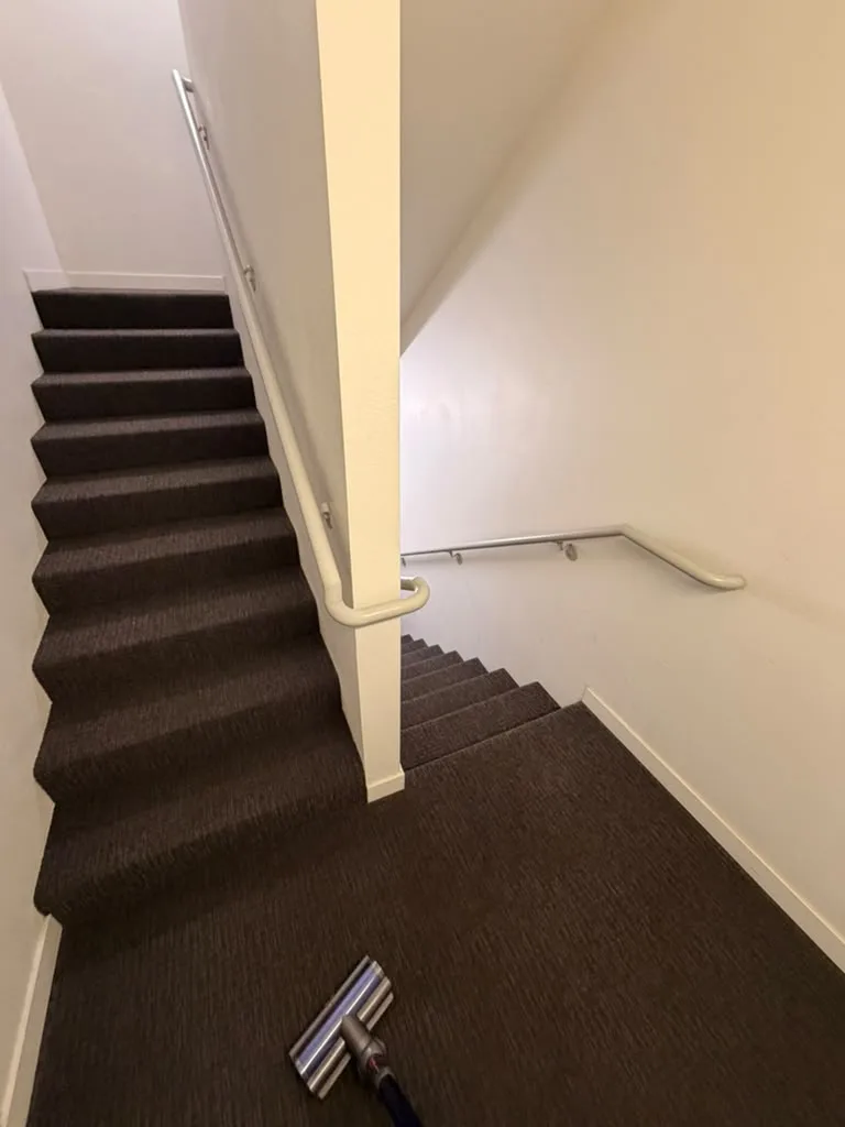 Carpeted stairwell at Verve Flats vacuumed during the weekly clean